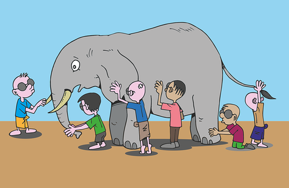 group of blind people touching an elephant